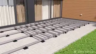 Installing WPC decking on an aluminum structure with adjustable decking pedestals.