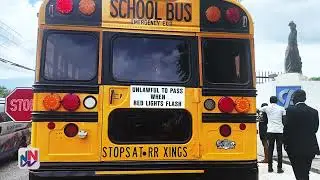 Transport Minister Daryl Vaz shows off buses for Rural School Bus Programme