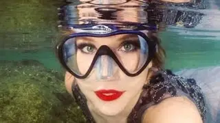Crazy women in under water latex full face gas masks and scuba diving gear dresses