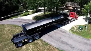 Side Dump Trailer unloading rock for a gravel driveway - Jet Trailers