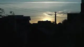 Sun goes up above the roofs of houses. Free time-lapse video footage
