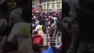 Haitian protestors march with Russian flags to seek protection from being reoccupied by the US.