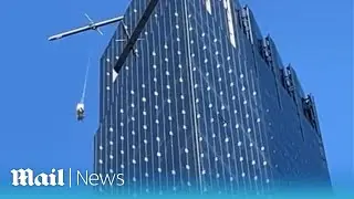 Terrifying moment window washers dangle from broken scaffolding at NYC high-rise