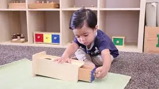 Montessori Sensorial: Object Permanence Box in toddler room