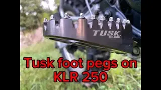 Tusk billet aluminum footpegs on a KLR 250