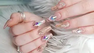Gel nail extensions on tips with marble french and crystals placement