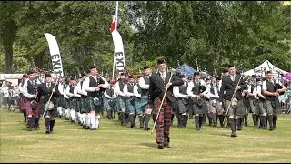 Drum Majors lead the massed Pipe Bands march off after opening parade 2023 Aberdeen Highland Games