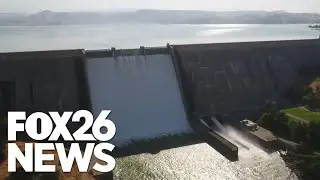 Stunning view of Millerton Lake spilling over the top of Friant Dam in Central California.