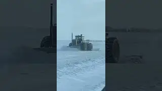 Large tractor plowing snow