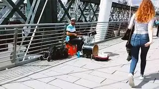 Busker drumming on a bridge, River Thames, London 4K
