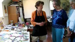 Artist Nancy Cawdrey demonstrates her painting technique for studio visitors.