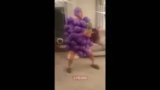 Guy wearing grapes costume dancing