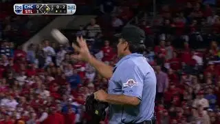 CHC@STL Gm1: Home-plate umpire checks the baseball