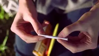 Jeanne rolls a cigarette