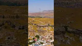 Vertical video. Urgup, Nevsehir, Turkey. Drone approach to rocky cliff showing abandoned dwelling...
