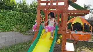 Kids play with Backyard Discovery Tucson All Cedar Wood Playset Swing Set