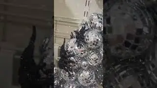 Spooky shiny home decor! Shiny disco ball spider wreath. #halloweendecorations