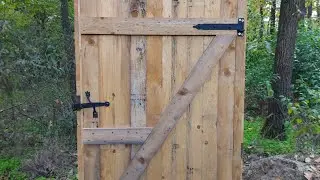 Outdoor toilet building with forged latch