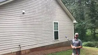 Softwashing some vinyl siding.