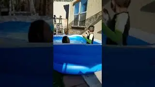 Pregnant mom & son enjoying the backyard pool