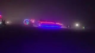 The Monaco tows The Snail through a dust storm. Black Rock City, 2024.