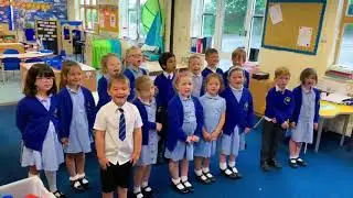 Children sing the Welsh national anthem to support the national team against Denmark