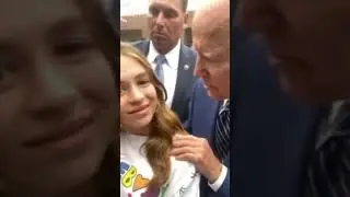Joe Biden sniffing hair again. She seems creeped out!