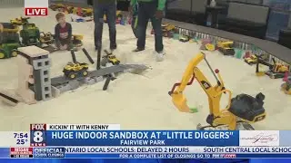 Kenny's having fun in a huge sandbox at Little Diggers