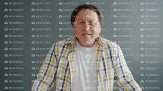 Angry Asian man yelling gesturing expressing anger looking at camera in studio