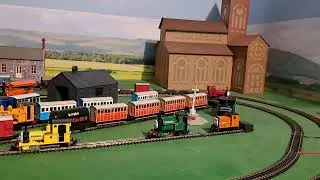Bachmann Skarleoy pulling 4 brown 3 red slate wagons, red box van and blue brakvan 