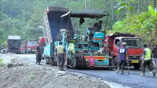 The Process of Construction Equipment Paving a Winding Hill Road Using Hot Mix Asphalt