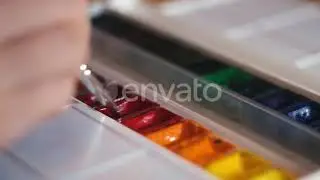 Putting paint brush into colorful oil paints | Stock Footage - Envato elements
