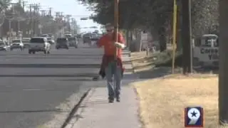 Man With Cross Walks His Way Through The Tall City