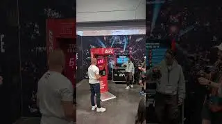 UFC legend George St Pierre on the punching machine at Fanatics Fest NYC
