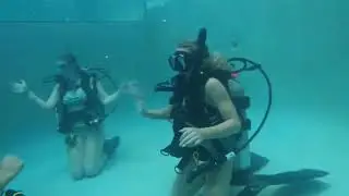 Female scuba divers training in pool