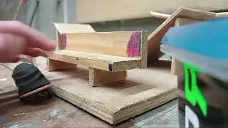 fingerboard tricks on a wooden bench.