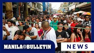 Catholic devotees line up at Quinta Market for Sunday Mass at Quiapo Church, Manila