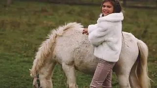 A Young Model Girl On The Farm With Sheeps And Pony