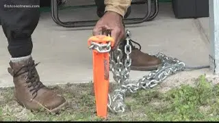 Man chained to sand, protesting closure of African-American camping area at American Beach in Nassau