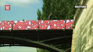 Romantic street art replaces love locks on Paris bridge