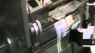 Tronics S1000 Labeller applying onserts in a saddle stitcher