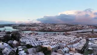Snowy rooftops overlook Derry city.