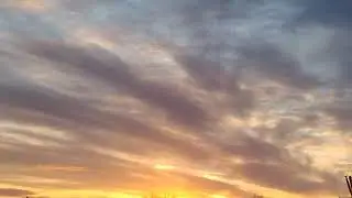 Golden Sunlight Shines Out Under Wispy Grey Clouds Just Before The Sunset