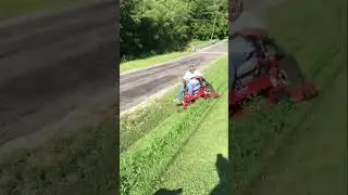 How NOT to mow, trying to hold the mower on the hillside.