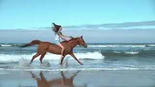 Super slo mo women riding horses at beach Amazing woman