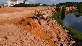 Really Pay Attention the Landfill Operator Bulldozer Push Stone and Dump Truck Unloading Stone Fill