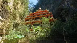 Moving towards the Sam Poh Tong Temple surrounded on all sides by steep limestone cliffs in Malaysia