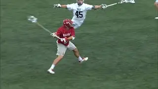 Shot from Harvard LSM Jack Breit breaks through the goalie's pocket