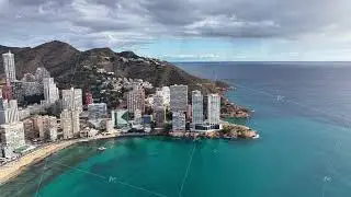 Remotely operated drone records panoramic images of waterfront structures and scenic terrain