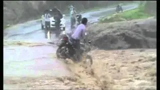 Biker Falling intoOver Flowing River While Crossing Bridge